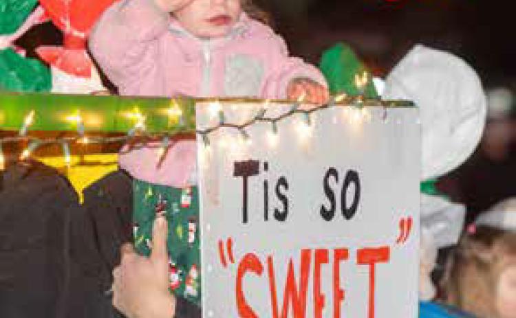 A child is shown in the Calera Christmas Parade.