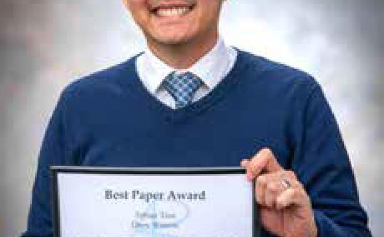 Dr. Arthur Tran with his award for “Best Paper” from the Academy of Business Research Fall Conference. Dan Hoke | SE