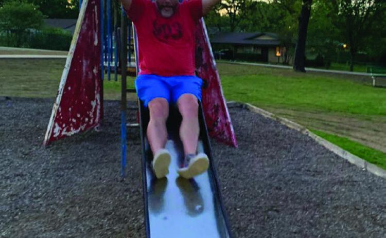 Ronnie Cubley goes down the rocket slide at Dixon Durant Park. Cubley visited the slide after learning the city was going to remove the slide while leaving the rocket intact. However, the city now says the rocket slide will be refurbished and will still include a slide. Photo provided