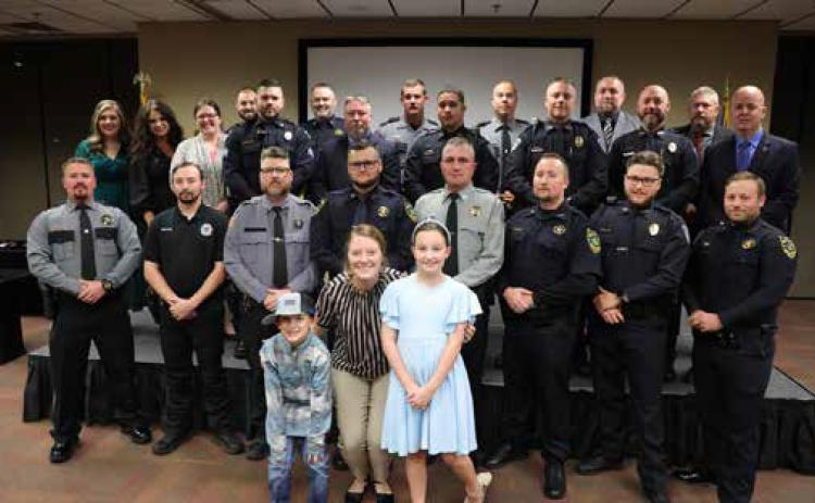 Pictured along with the eight academy graduates are the program administrators and instructors and the family of Jarid Taylor. Photo provided