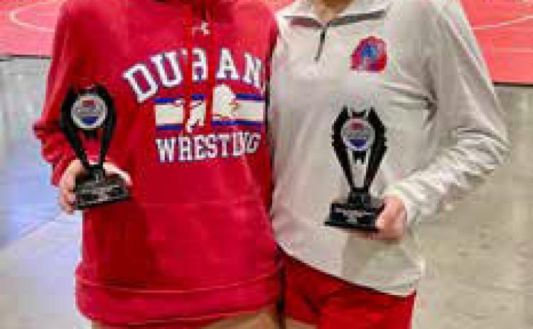Addison Polk and Loryn Lopez are Midwestern Conference Tournament wrestling conference champions. Photo by Kelley Polk